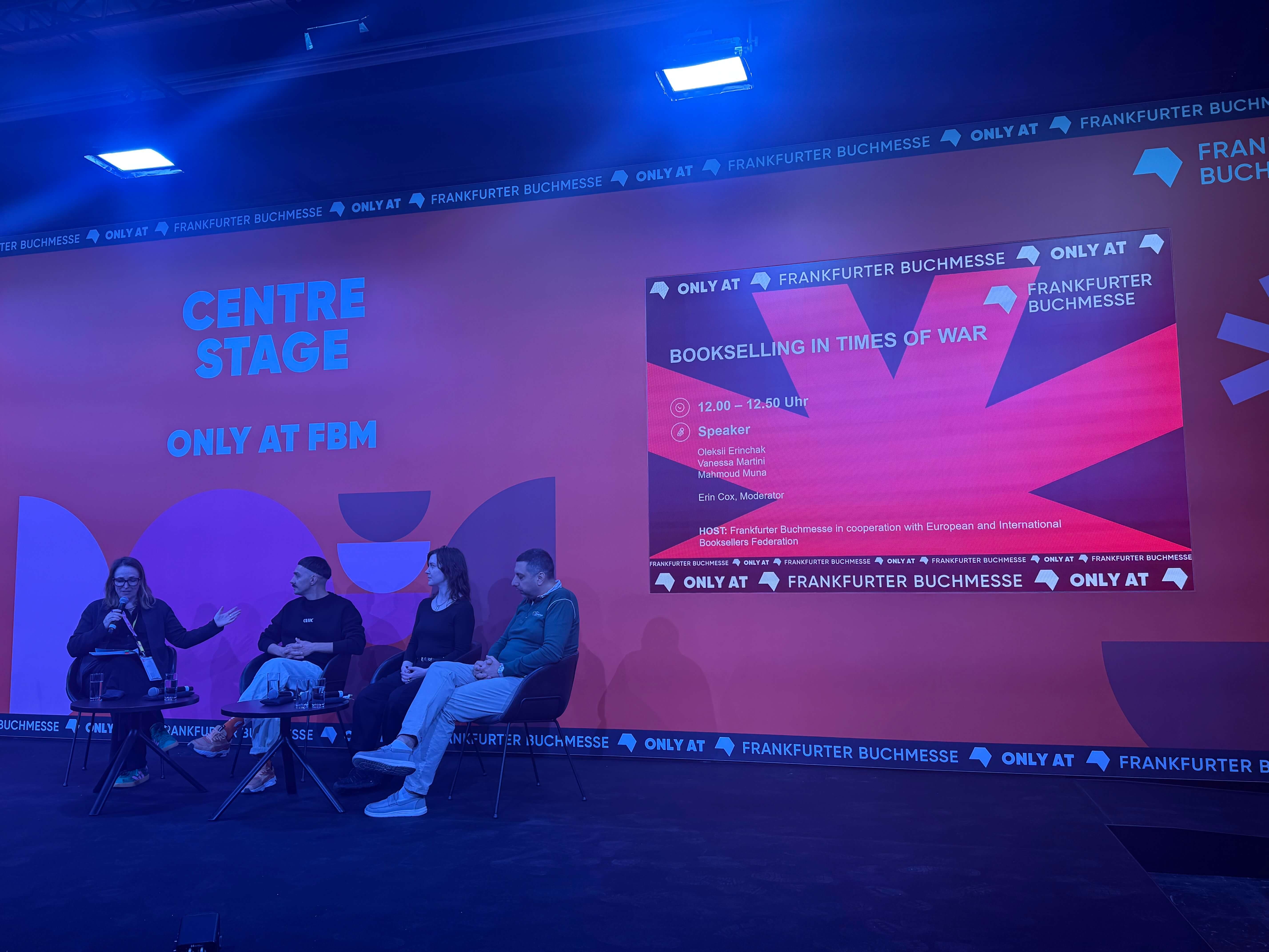 Shot of the stage with the panelists and moderator.