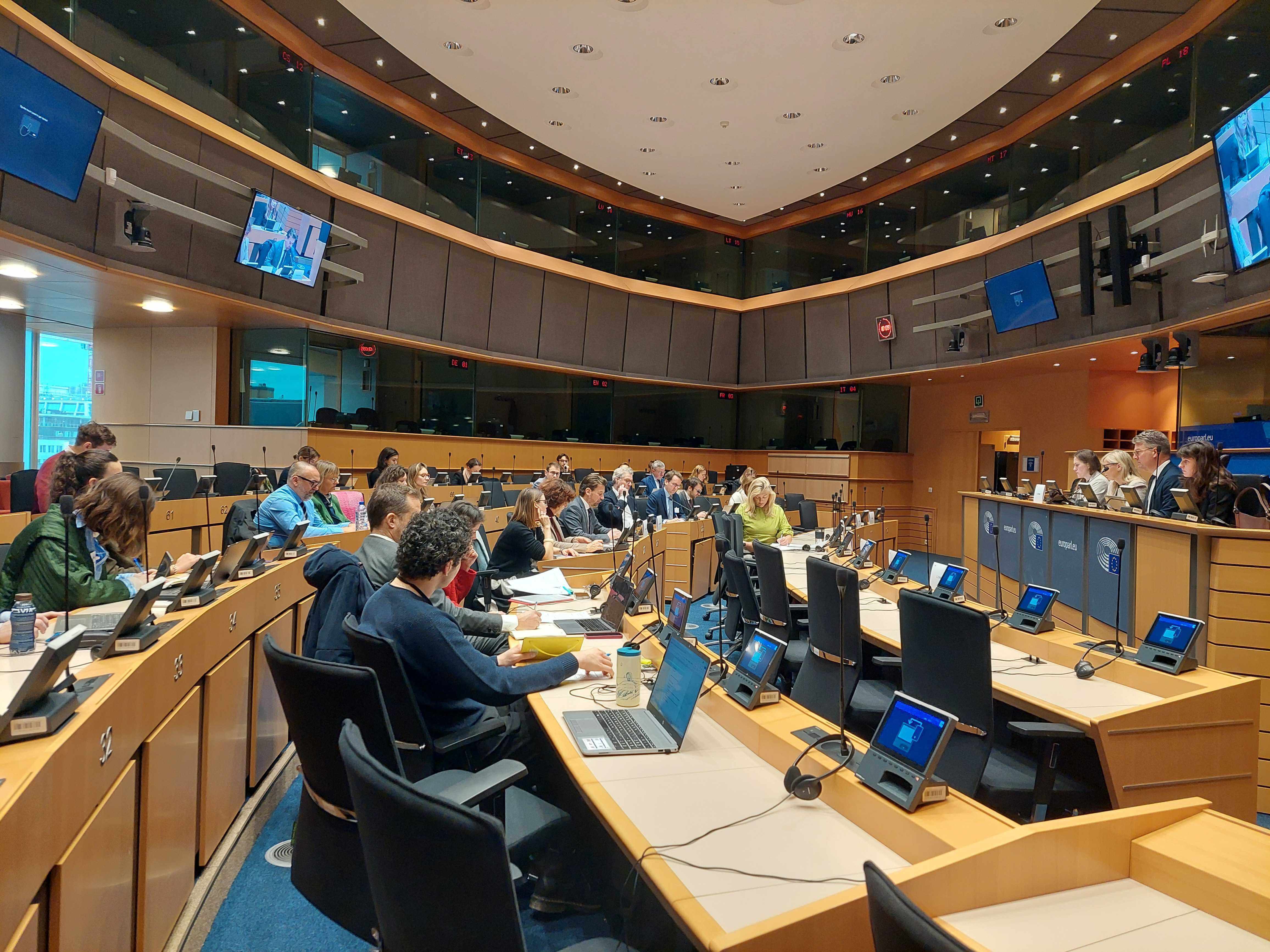 Speakers sitting in a room of the European Parliament.