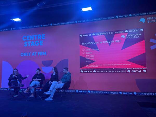 Shot of the stage with the panelists and moderator.