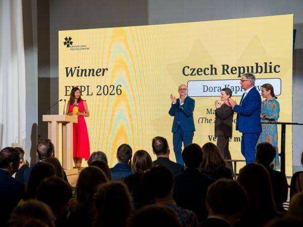 EUPL 2026 Laureate Dora Kapralova receiving her prize on stage.